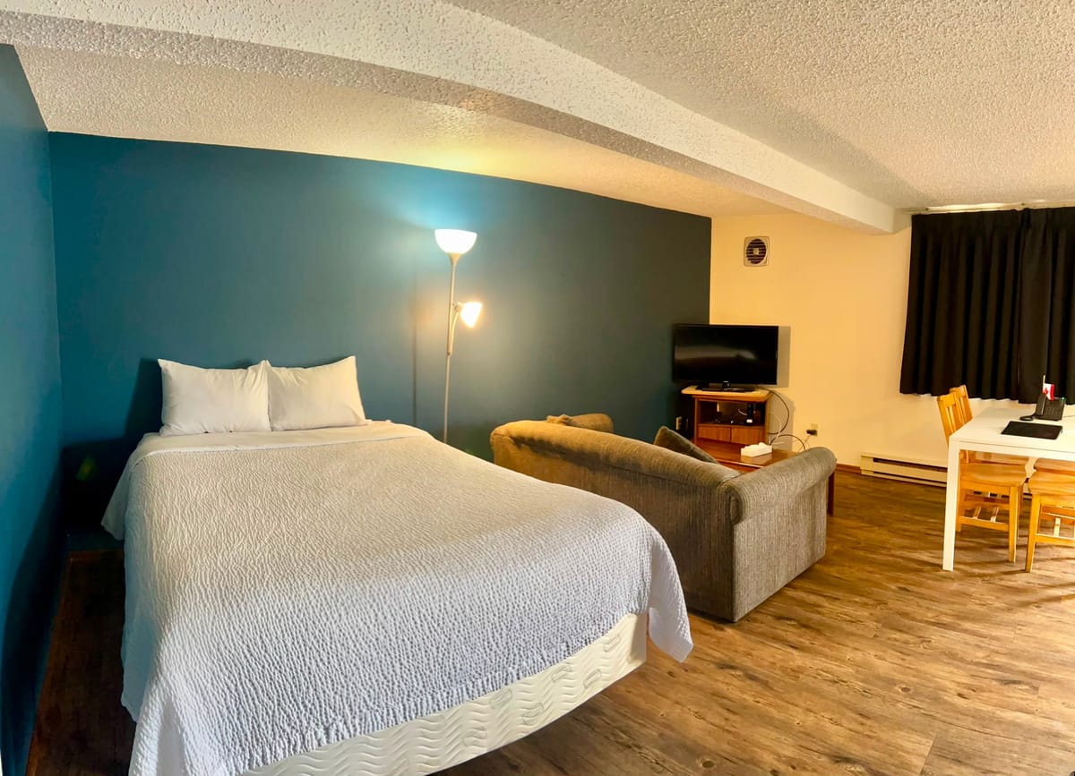Bedroom with an extra bed in the living area at a Birch Grove apartment