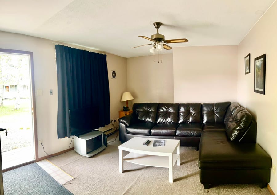 Bright living room with sofa in a Birch Grove suite